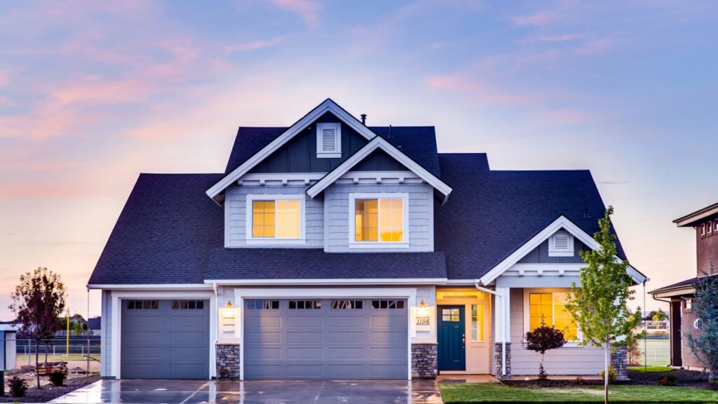 blue suburban house during dusk with lights on