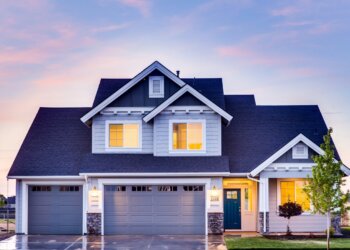 blue suburban house during dusk with lights on